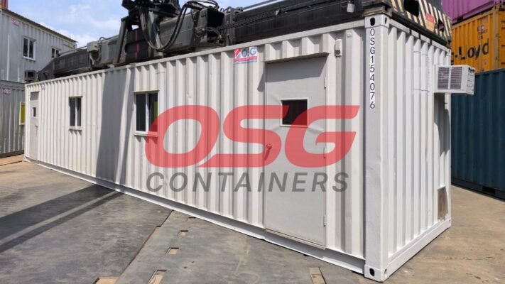 A white shipping container office with windows and a door.
