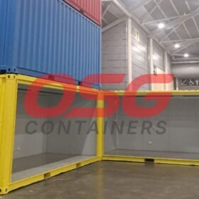 Stacked shipping containers, one open, in a warehouse.