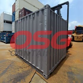 Shipping containers are stacked and moved by forklifts.