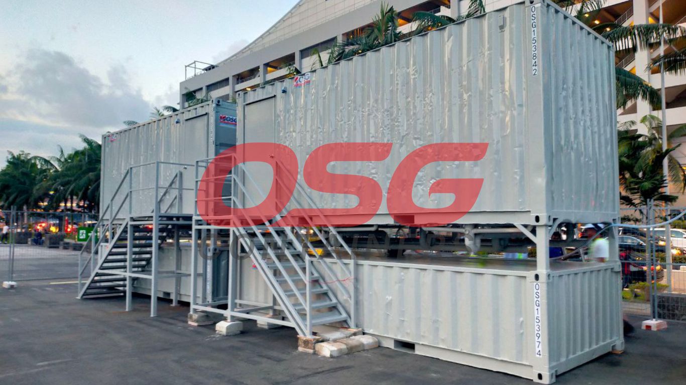 Stacked shipping containers with stairs and a large red OSG logo.