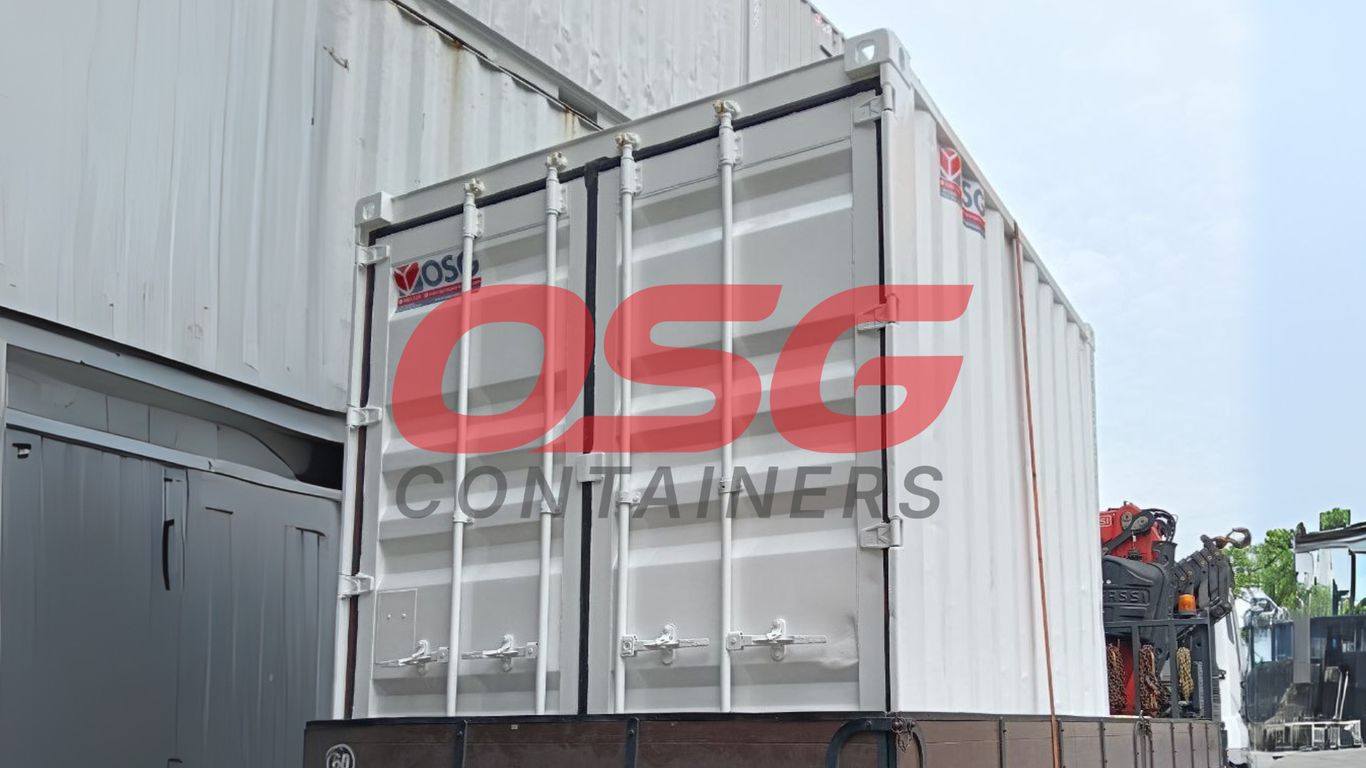 White shipping container on a truck with a crane.