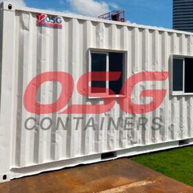 White shipping container office with windows and door.