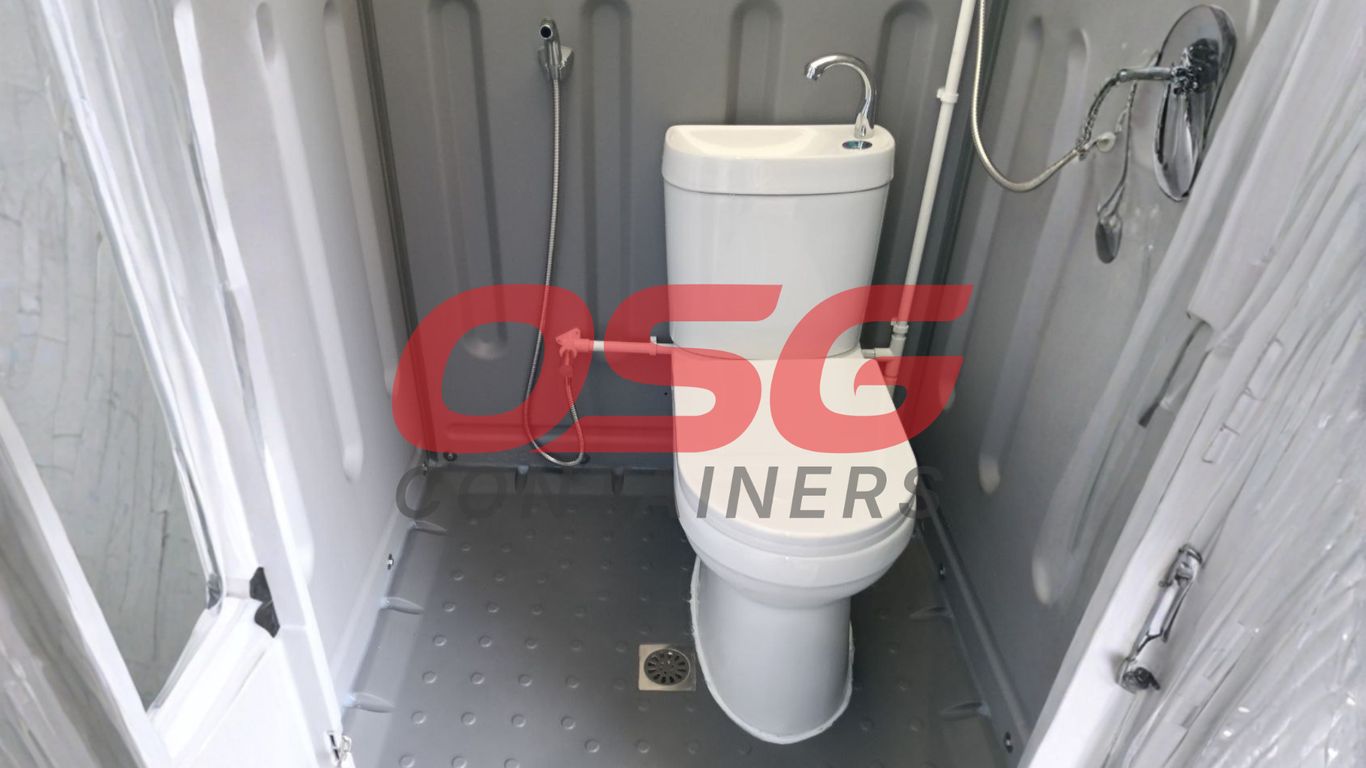 Compact portable toilet and shower unit with sink and bidet sprayer.