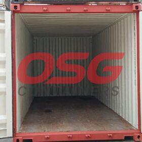 Open red shipping container with a wooden floor and white interior.