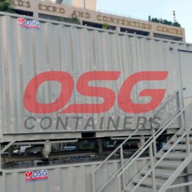 OSG containers stacked with stairs in front of a building.
