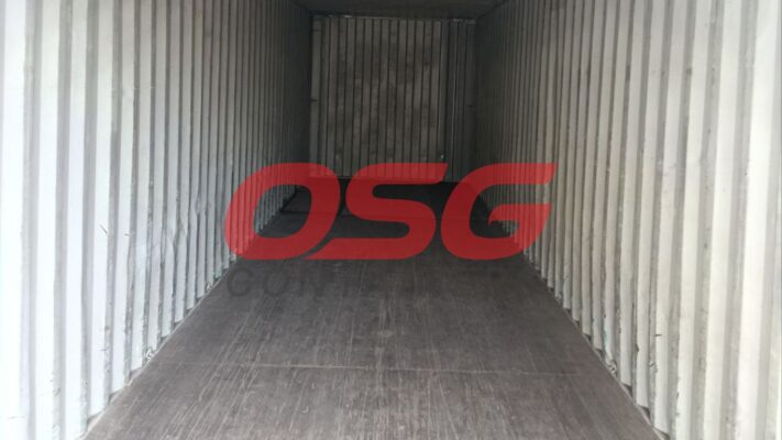 Inside view of an empty shipping container with corrugated walls.