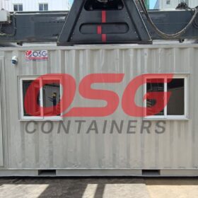 A shipping container office with windows and a door.