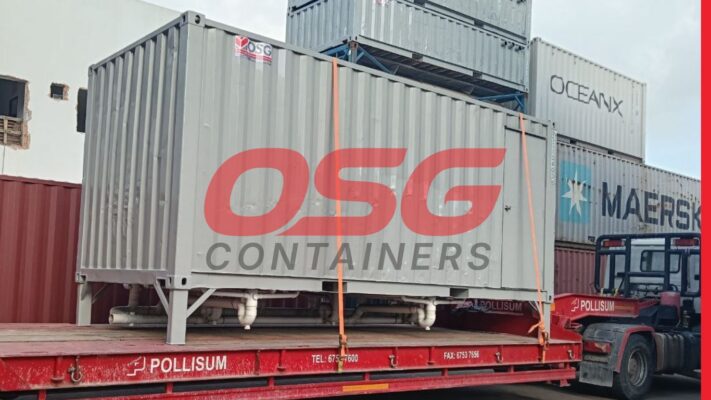 Shipping containers stacked on a flatbed truck, ready for transport.