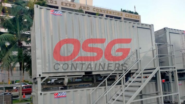 OSG containers stacked with stairs in front of a building.