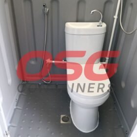 Compact portable toilet and shower unit with sink and bidet sprayer.