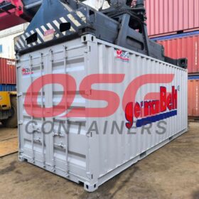 A container is being lifted by a crane at a shipping yard.