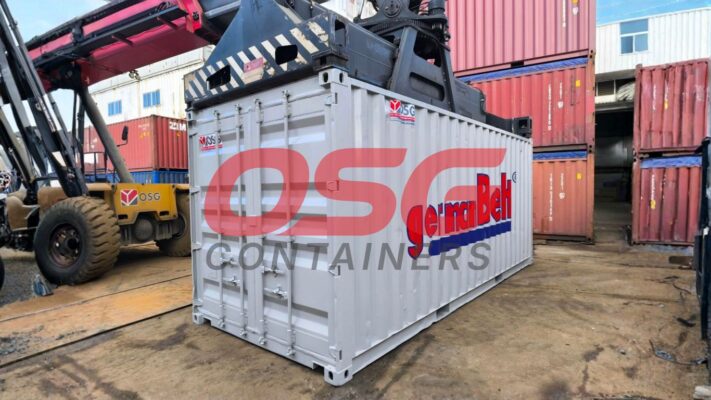 A container is being lifted by a crane at a shipping yard.