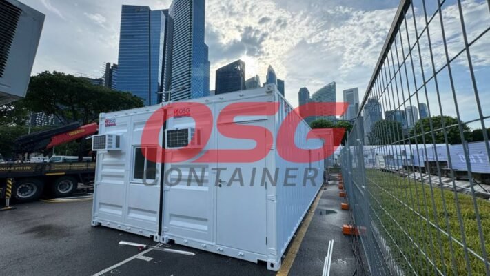Modular containers with air conditioning units in a city setting.