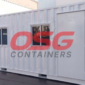 White shipping container office with windows and door.