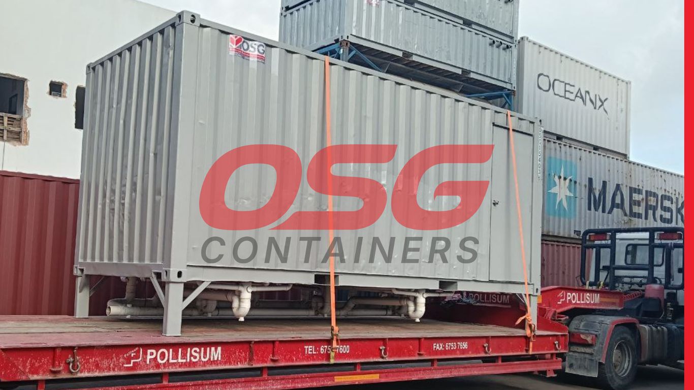 Shipping containers stacked on a flatbed truck, ready for transport.