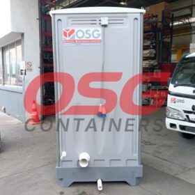 Portable toilets and a delivery truck are parked outside.