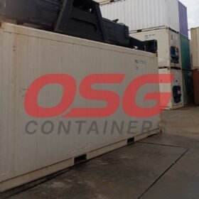 Stacked shipping containers at a port with a crane overhead.