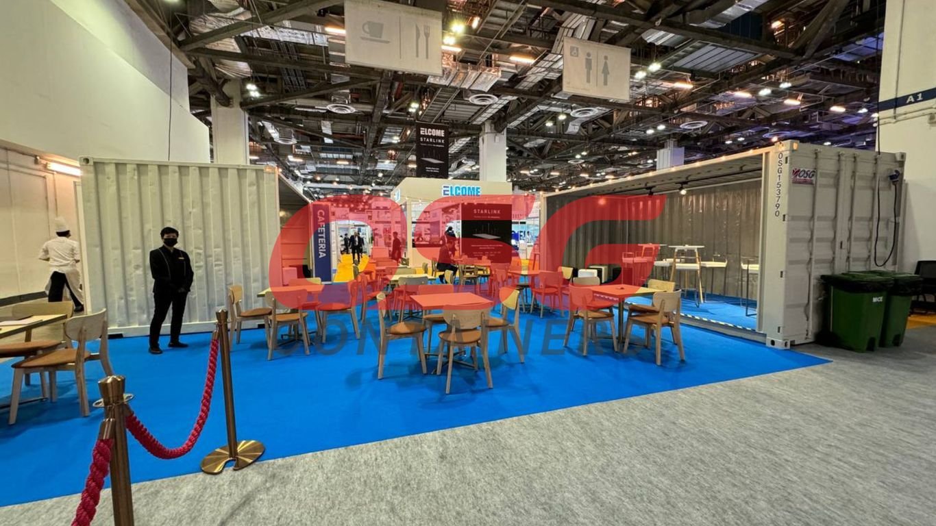 A cafeteria setup inside shipping containers at an event.
