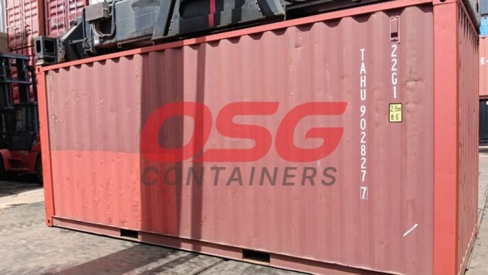 Red shipping container with OSG Containers logo and markings.