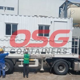 White container office on a truck with workers.