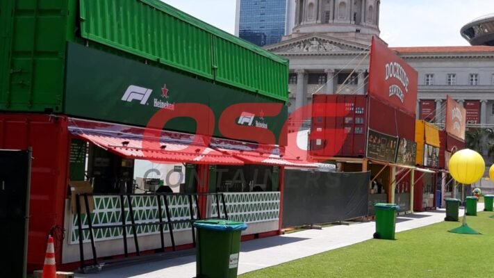 Shipping containers converted into food stalls with branding.
