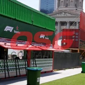 Shipping containers converted into food stalls with branding.