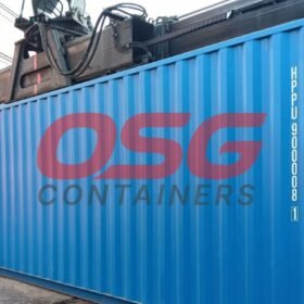 A large blue shipping container is being lifted by a crane.