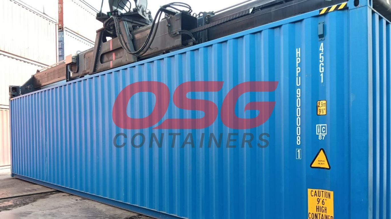 A large blue shipping container is being lifted by a crane.