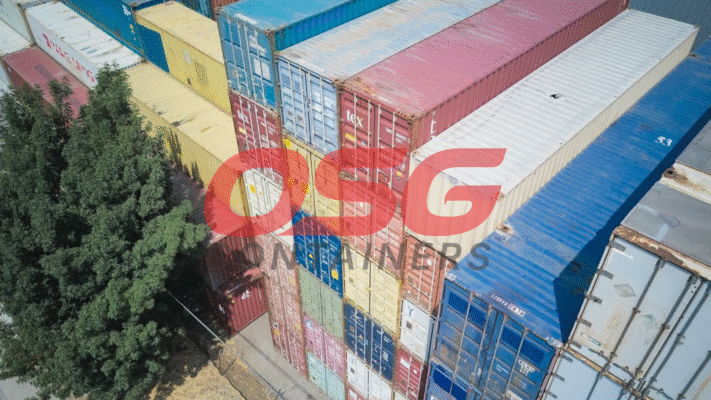 Aerial view of stacked shipping containers in various colors.