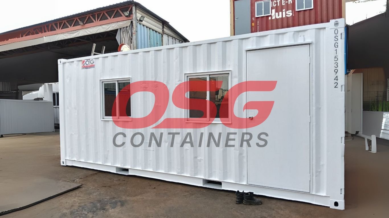 White shipping container office with windows and a door.