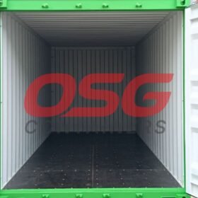 Empty green shipping container with doors open, showing interior.