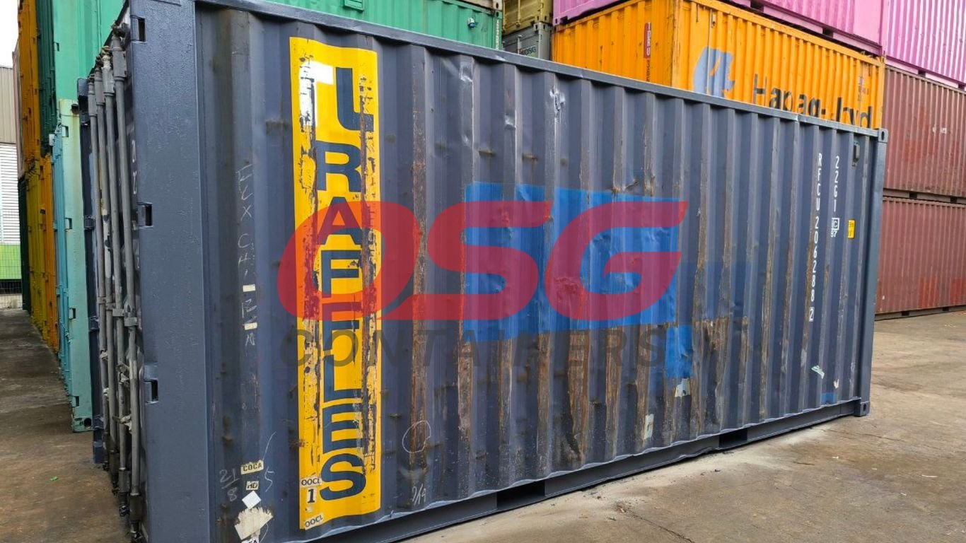 A dark gray shipping container with red and blue logos.