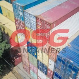Aerial view of stacked shipping containers in various colors.