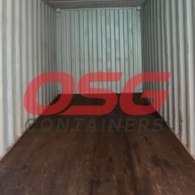 Inside of an empty shipping container with a wooden floor.